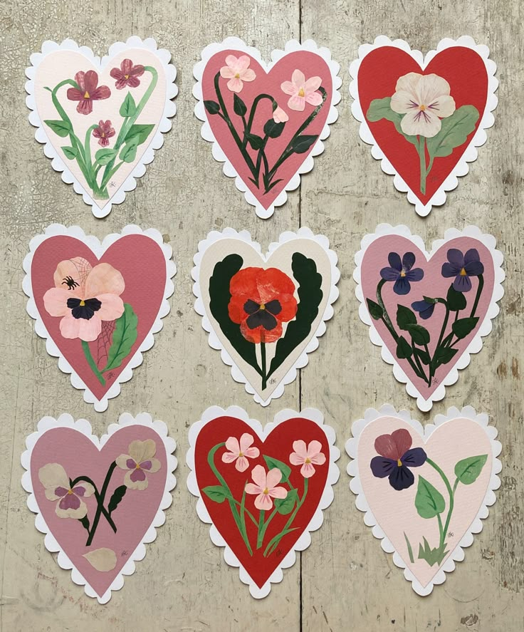 six heart shaped stickers with flowers on them