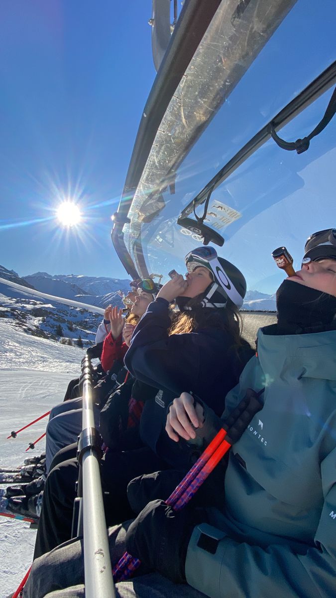 people sitting in the back of a ski lift