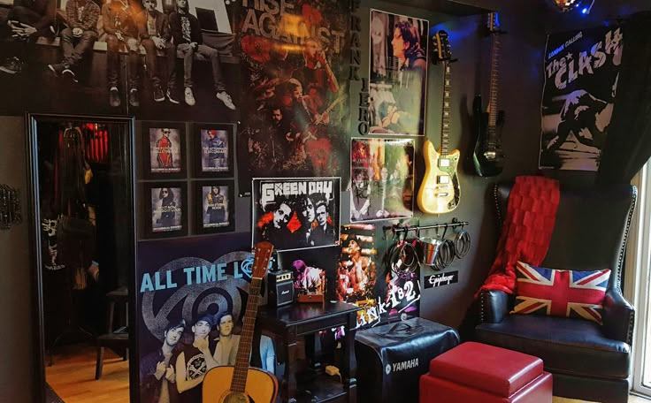 a room filled with guitars and pictures on the wall next to a chair in front of a window