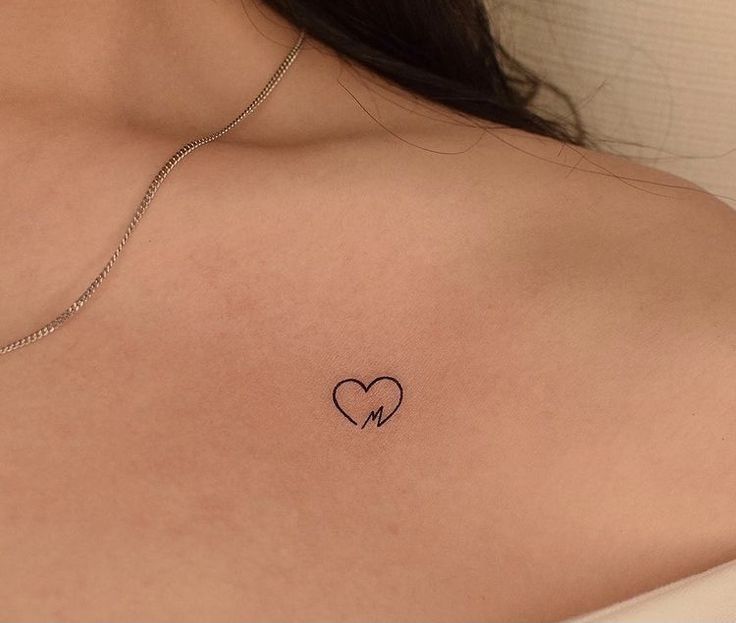 a woman with a heart tattoo on her chest