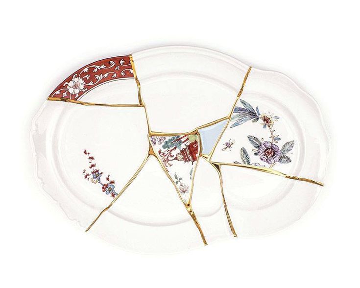 two pieces of broken glass sitting on top of a white plate