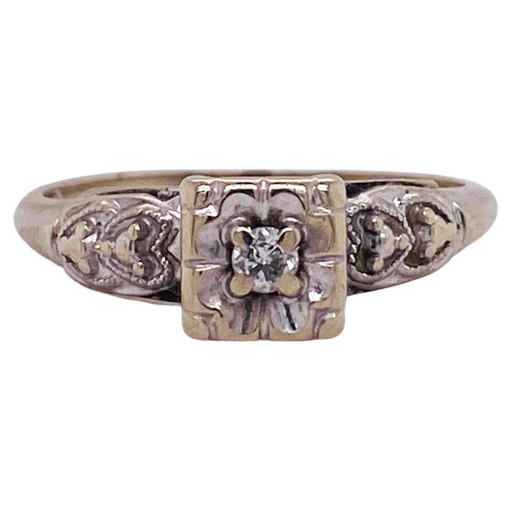 an antique style diamond ring with filigrees