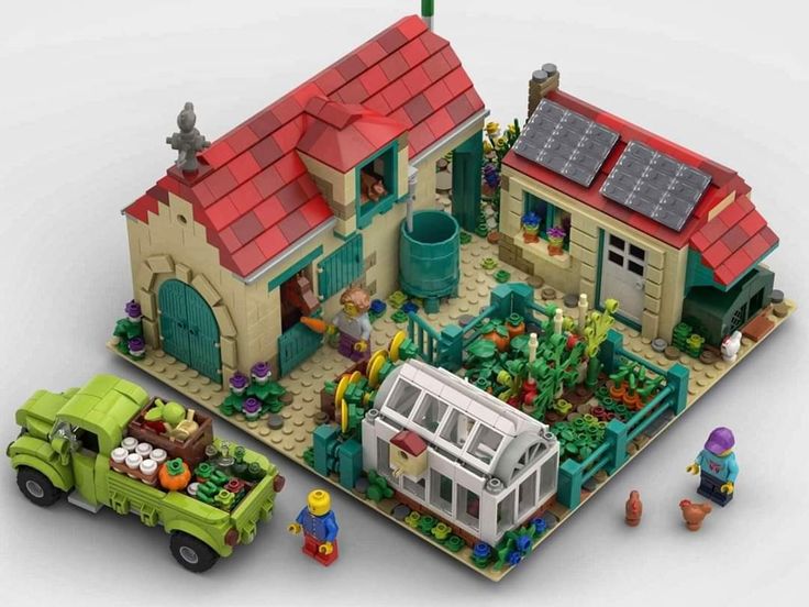 a lego model of a house with cars and people around it