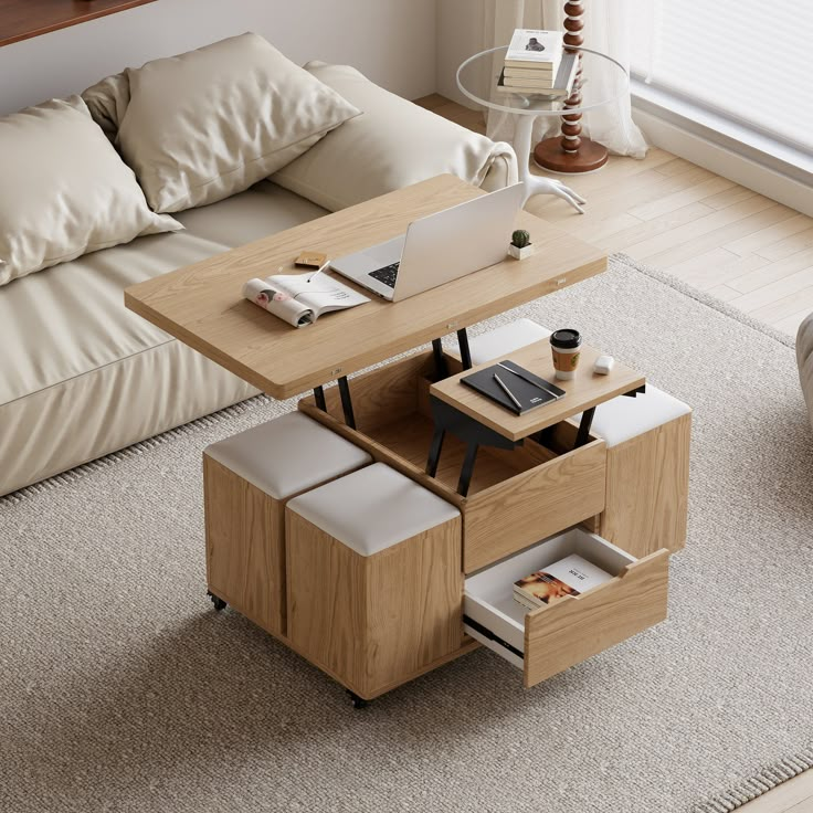 a living room with a couch, coffee table and laptop on top of the table