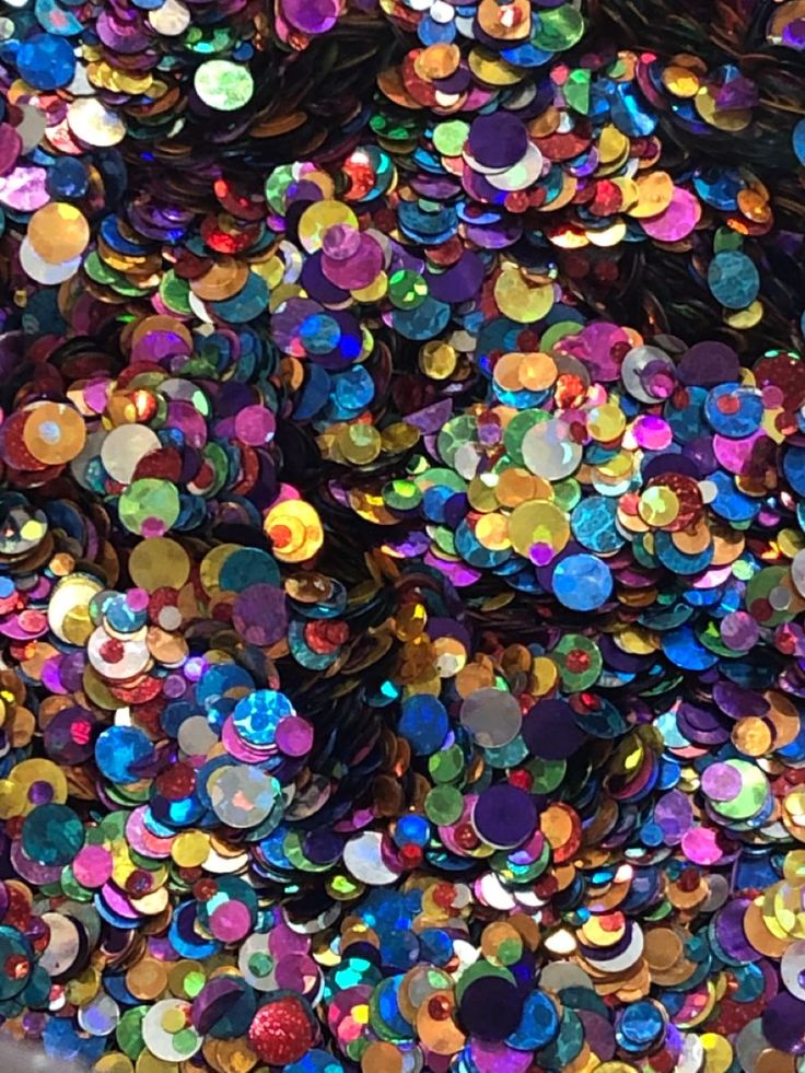 many different colored sequins are scattered on top of each other in this image