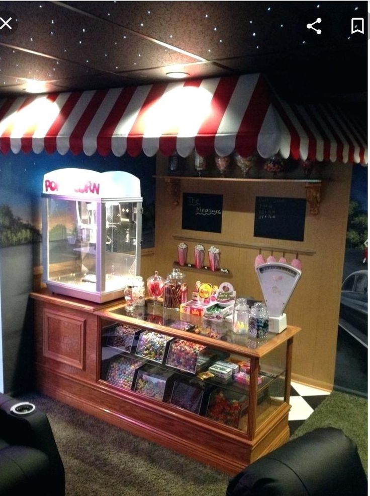 the inside of a candy shop with two black chairs