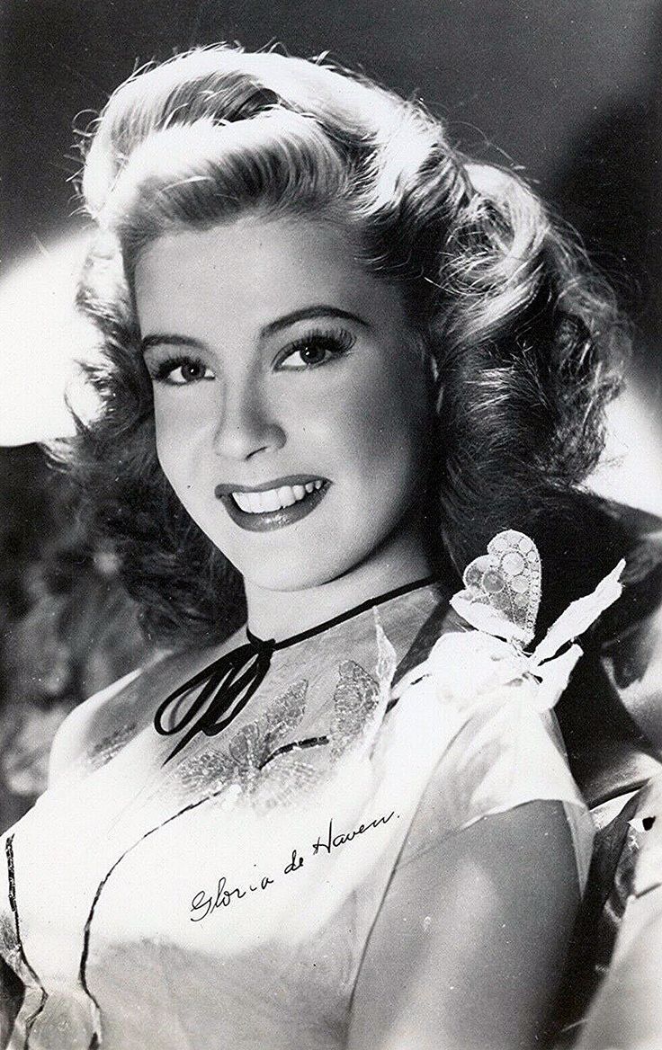 an old black and white photo of a woman with a heart on her shoulder, smiling