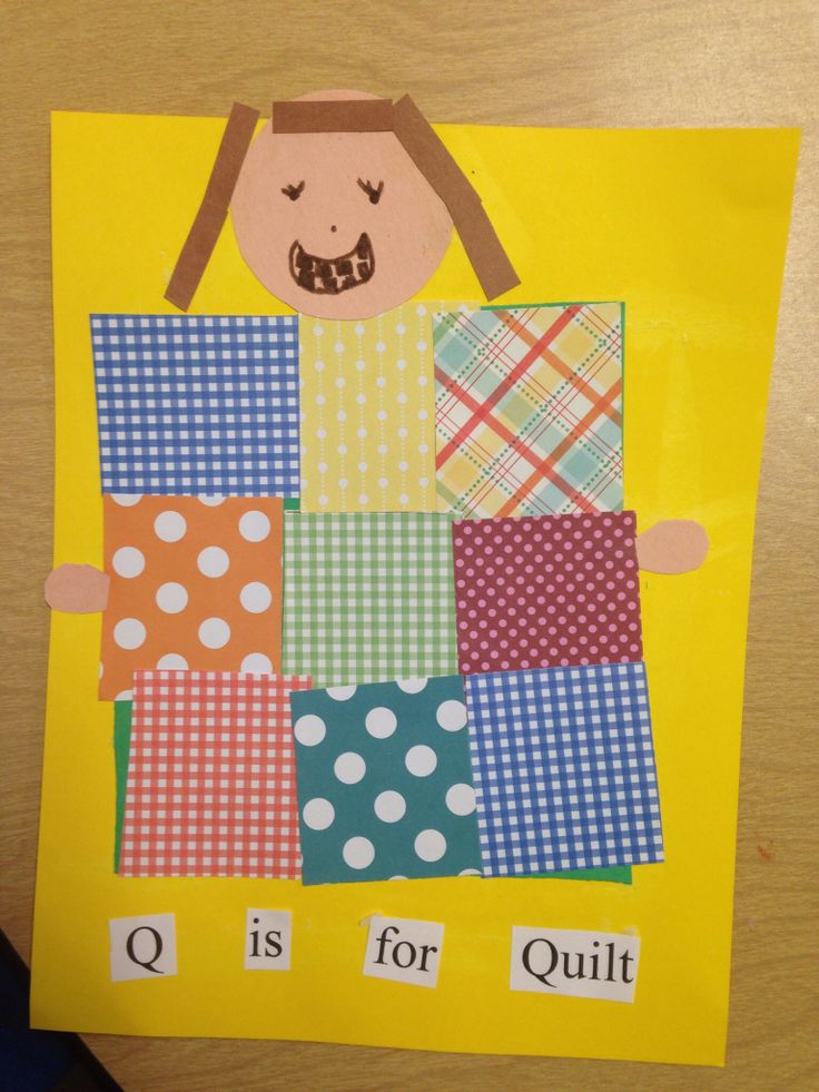 a child's paper cutout with the words q is for quilts