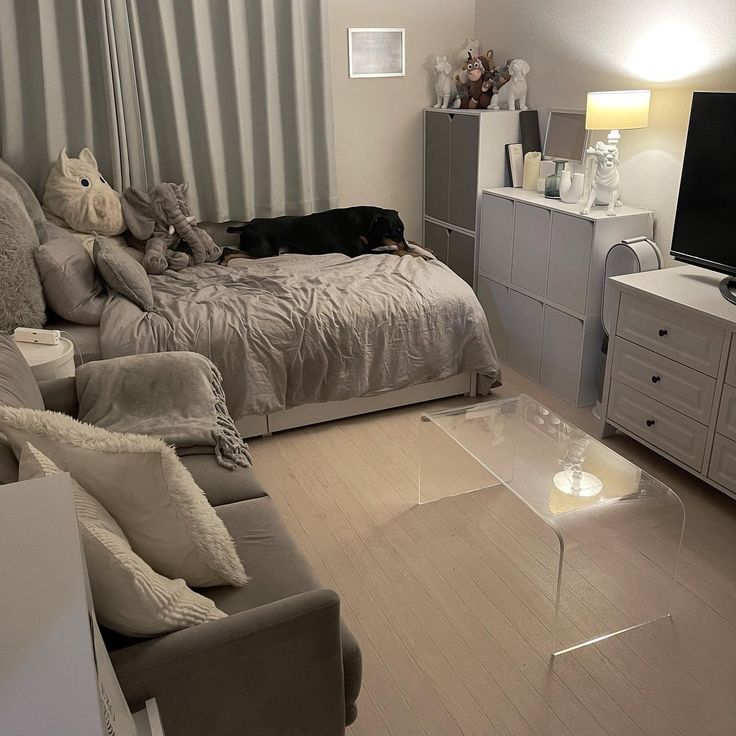 a living room filled with furniture and a flat screen tv on top of a wooden floor