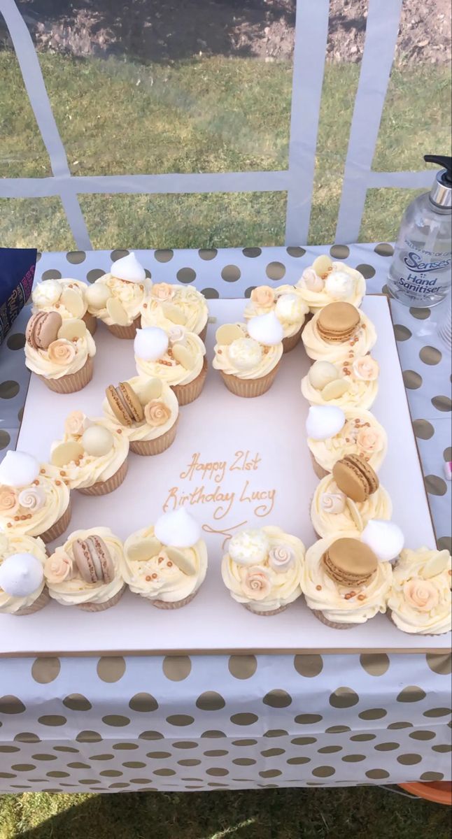 a birthday cake with cupcakes arranged in the shape of letter e