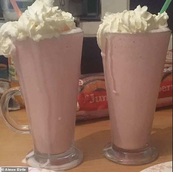 two glasses filled with whipped cream on top of a table