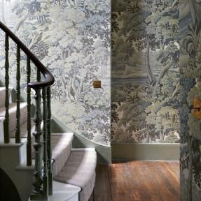 the stairs are lined with wallpaper in this house