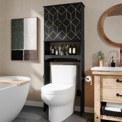 a white toilet sitting next to a bath tub in a bathroom under a round mirror