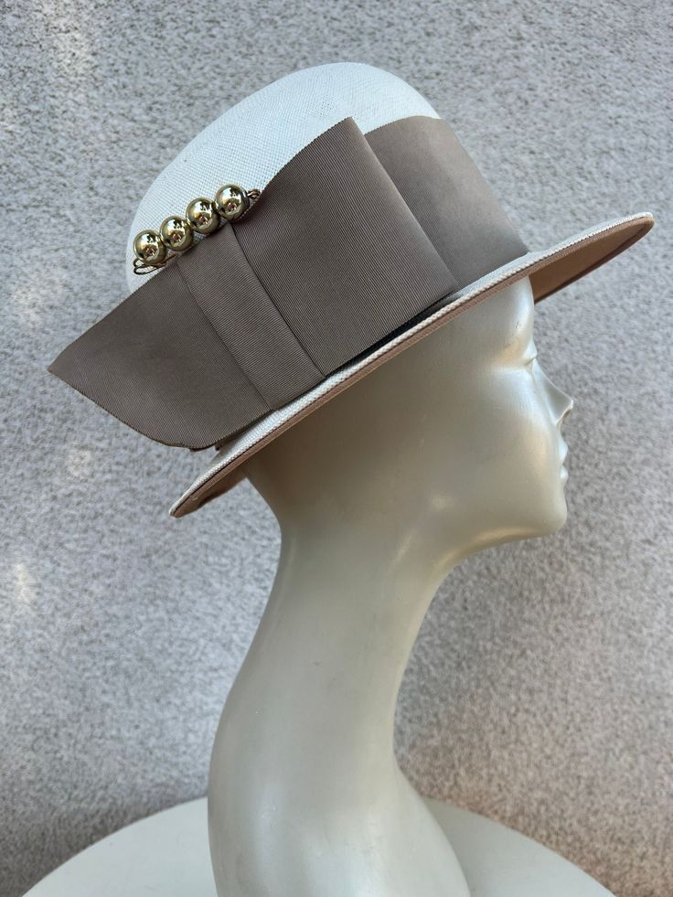 "Vintage white straw bowler style hat wide taupe grosgrain ribbon accent and hat pin sz 22 by Bullocks Los Angeles. Good to ok condition, Original netting over crown area has been remove ( damaged) and has some wear. Interior Brim lined with fabric. Measurements  Interior band 22\" Crown height 5\" Hat width 11\" Brim width 2\" Weight 1 pound" Imperial Beach, Jeweled Headband, Bowler Hat, Fancy Hats, Hat Pin, 1 Pound, Hat Pins, Straw Hat, Grosgrain Ribbon