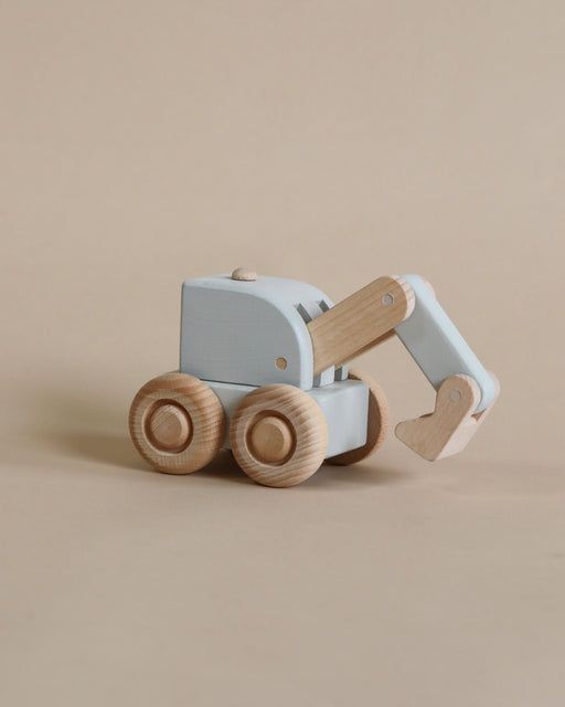 a wooden toy truck with wheels on a beige background