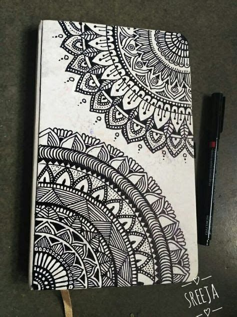 a notebook with black and white designs on it