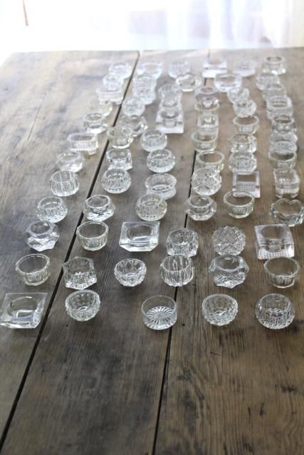 many clear glass dishes on a wooden table