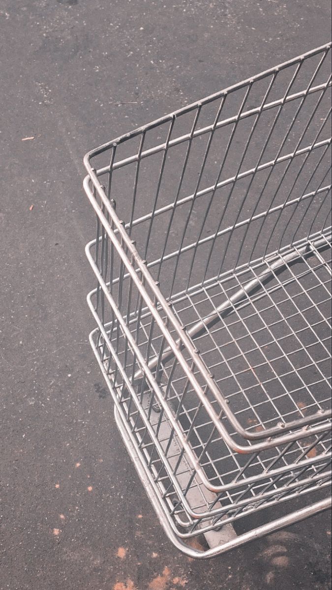 an empty shopping cart sitting on the ground