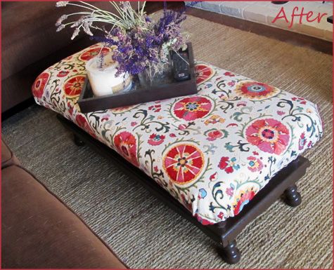 an ottoman with a flower arrangement on it