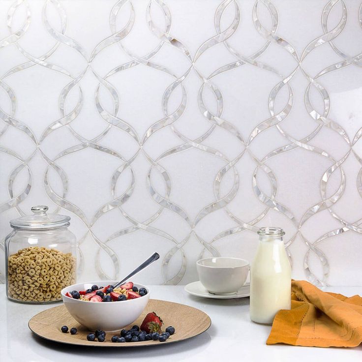 a bowl of cereal sits on a plate next to a jar of milk and a glass of milk