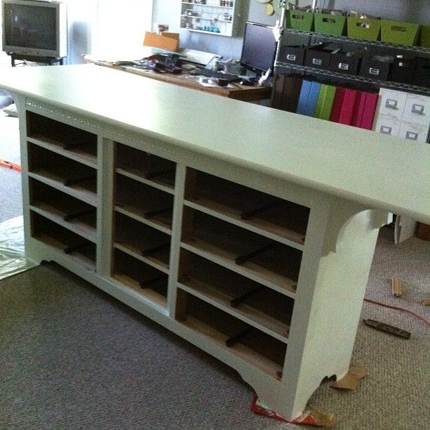 a large white counter with lots of drawers