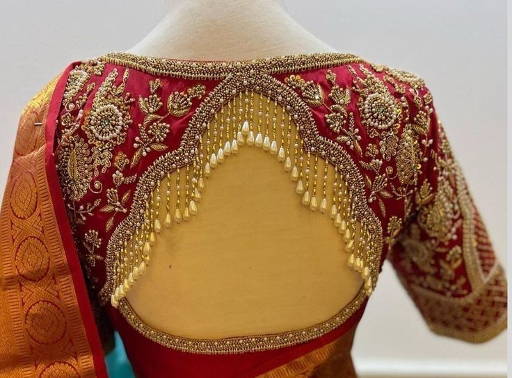 the back of a red and gold blouse