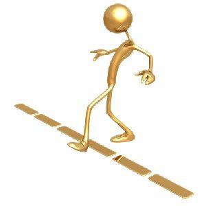 a golden man walking across a crosswalk with his hand in the air and one foot on the ground