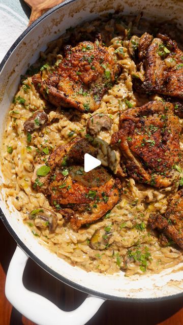 a pan filled with meat and pasta on top of a wooden table