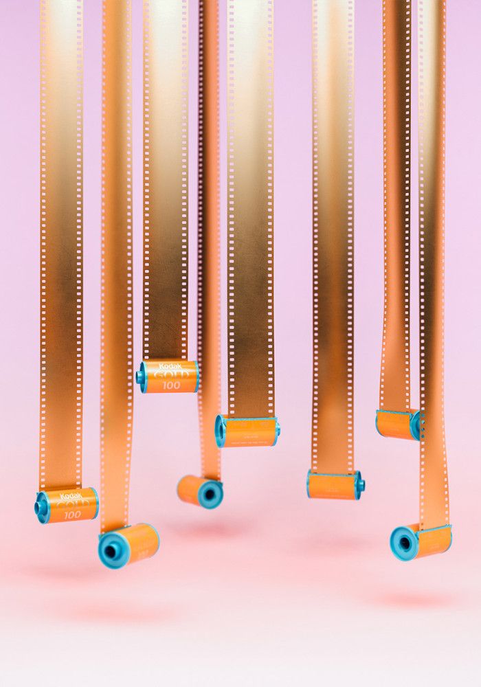 three skateboards with rollers attached to them against a pink background and two blue wheels are in the foreground