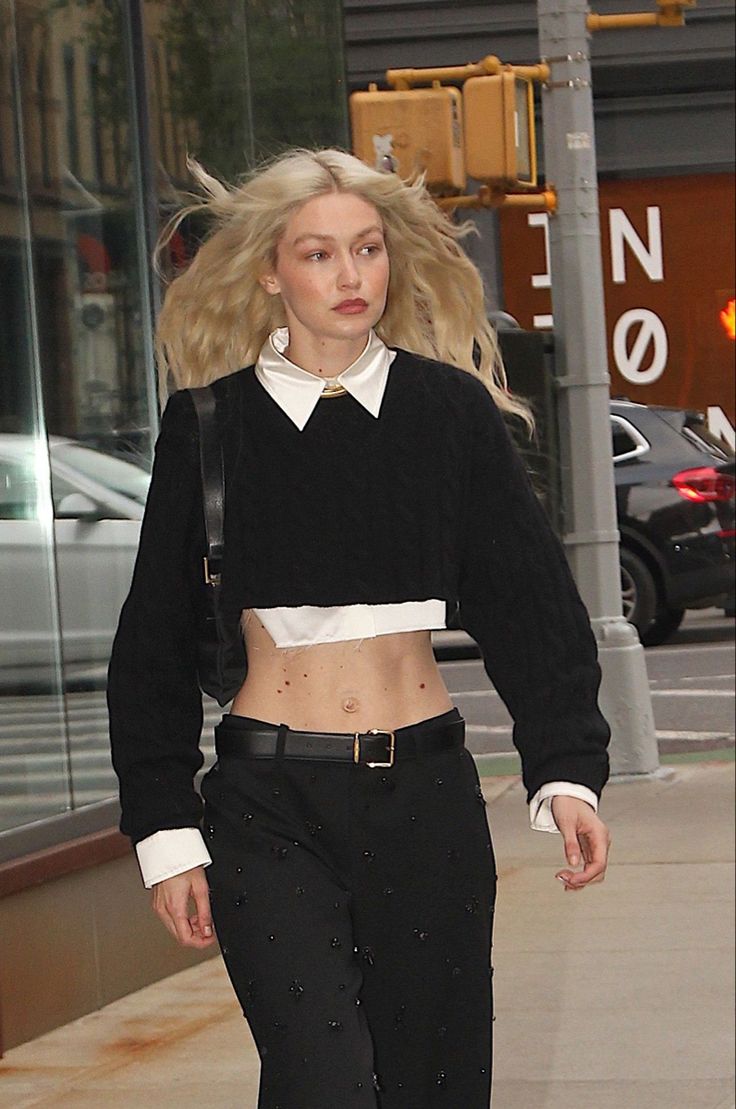 a woman with blonde hair walking down the street