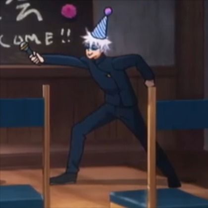 a man in a suit and party hat hitting a ball with a bat on stage