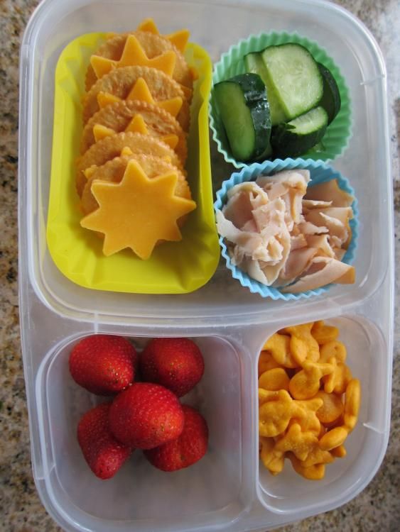 three plastic containers filled with different types of food