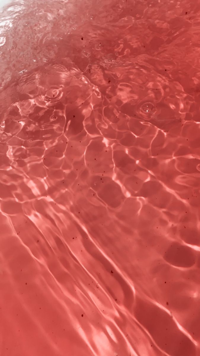 the water is red and clear with little ripples on it's surface, as seen from above