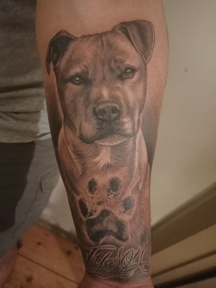 a man's leg with a dog tattoo on it