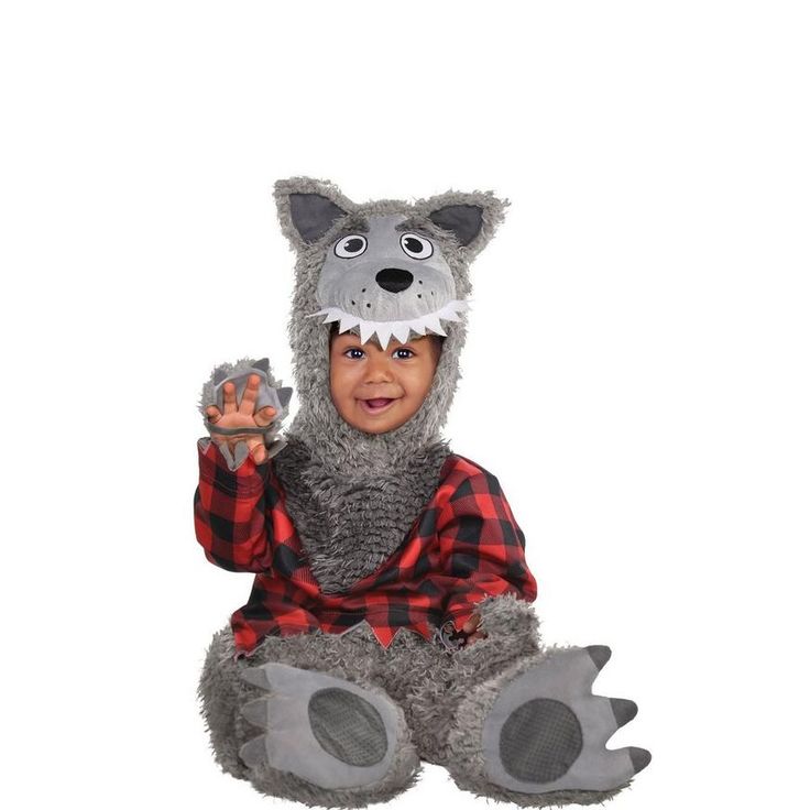 a little boy dressed in a costume that looks like a wolf sitting on the ground