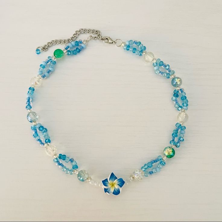 Blue Hawaii Tropical Beaded Necklace Handmade By Me And One Of A Kind! It Has Clear Beads And Loops Of Aqua Blue Tiny Beads. In The Middle Is A Beautiful Hibiscus Flower It’s A Short Necklace But The Length Can Be Adjusted To Wear It As A Choker As Well. Measures 14”-16” #Y2k #Coconutgirl #Surf #Tropical #Aesthetic Blue Beaded Flower Jewelry, Blue Bohemian Flower Beaded Necklaces, Blue Flower-shaped Beaded Jewelry, Summer Blue Necklaces With Spacer Beads, Summer Blue Beaded Necklace With Large Beads, Blue Beaded Necklaces For Jewelry Making In Summer, Blue Beaded Necklace With Spacer Beads For Summer, Blue Beaded Necklaces With Spacer Beads For Summer, Blue Adjustable Flower Necklace