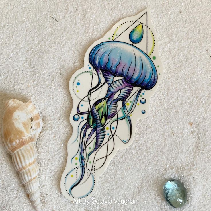 an image of a sticker with a jellyfish on it next to a seashell