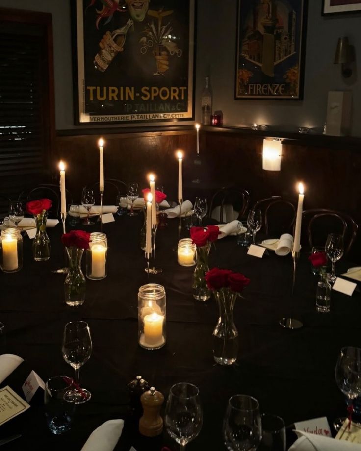 a table is set with candles and wine glasses