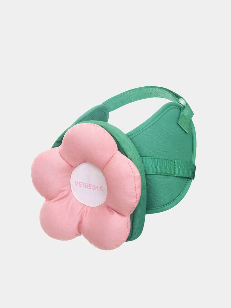 a green bag with a pink flower on it