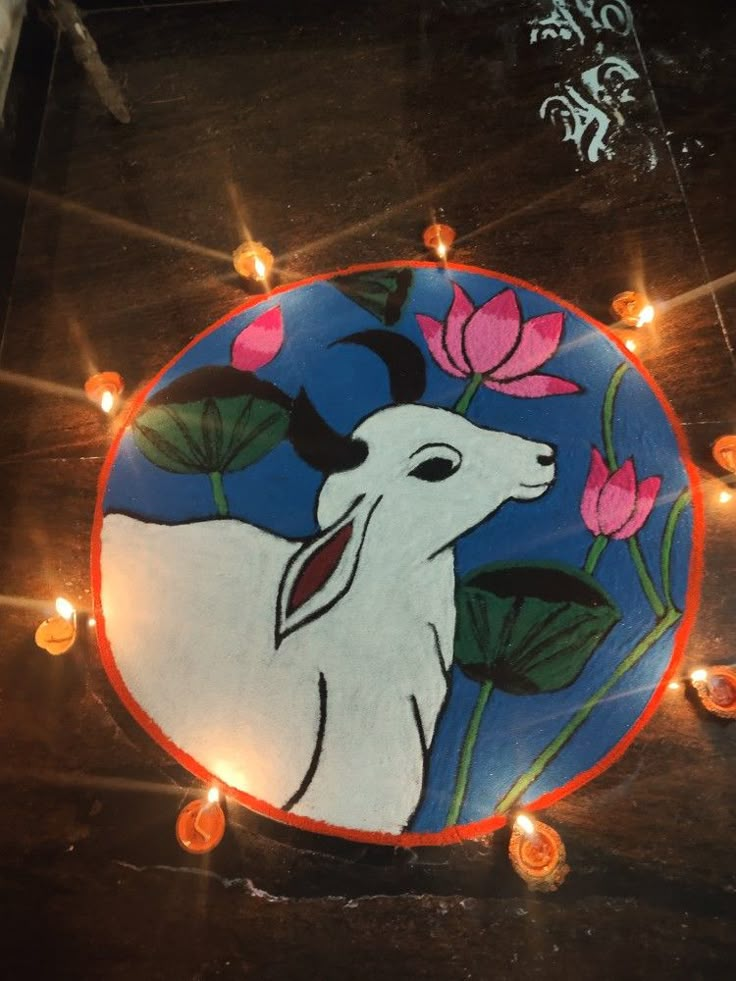 an animal painted on the ground with candles around it