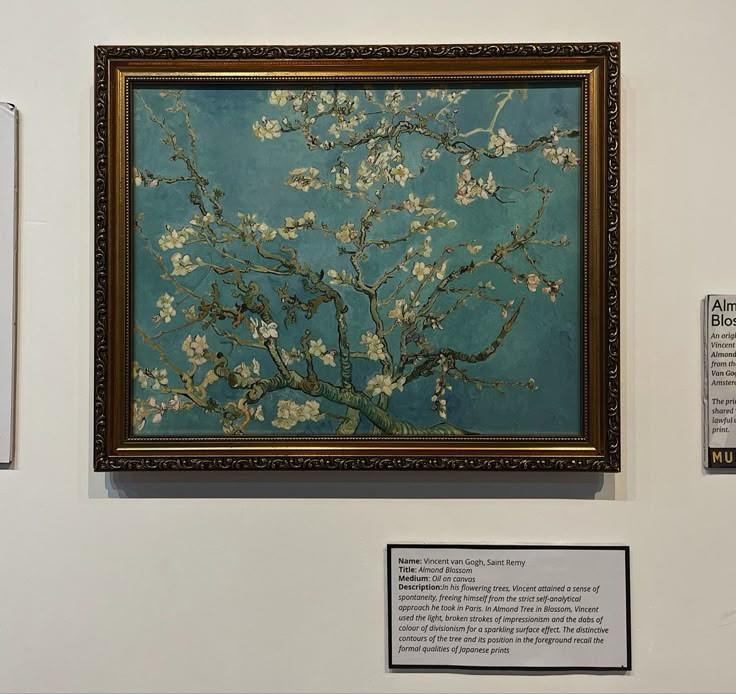 two paintings on display in a museum, one is blue and the other has white flowers