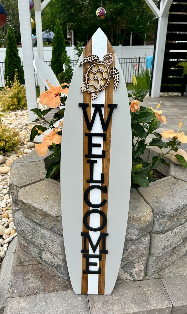 a surfboard with the word welcome written on it