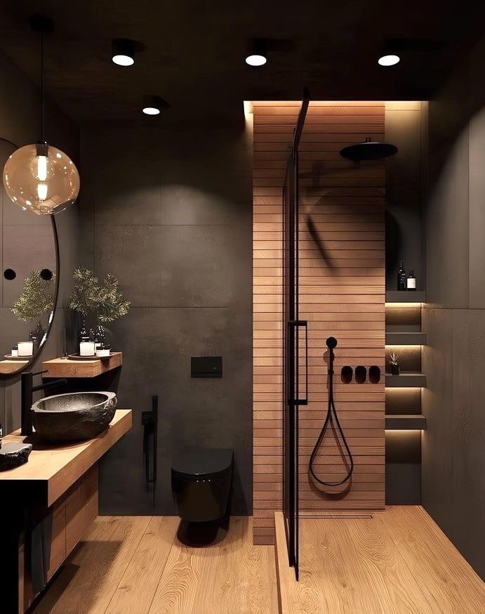 a modern bathroom with wooden floors and black fixtures on the walls, along with an open shower