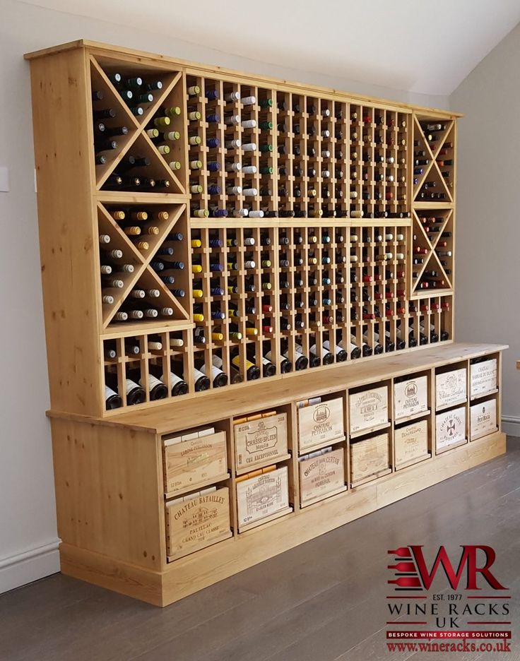 a wooden wine rack filled with lots of bottles