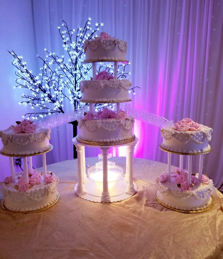 three tiered wedding cake with pink flowers on top