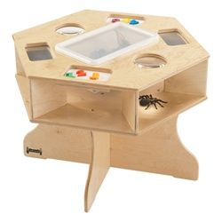 a wooden toy table with a spider on the bottom and an object in the middle