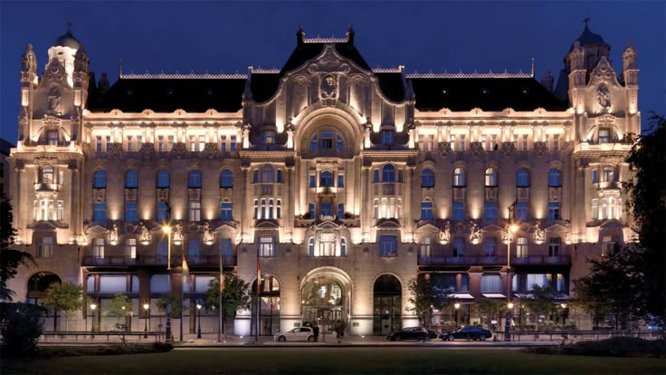 a large building lit up at night with lights on it's sides and windows