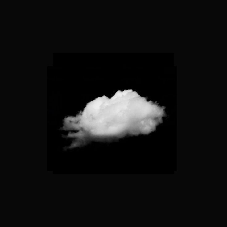 a white cloud floating in the dark sky