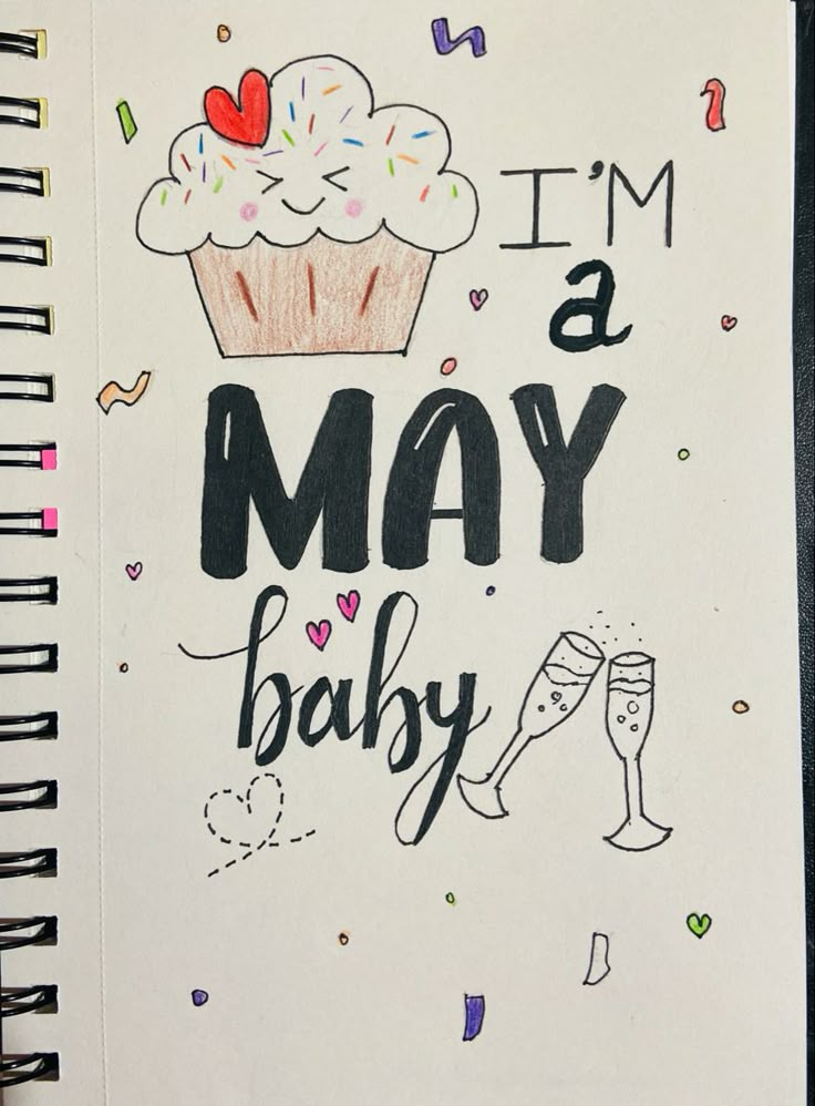 a spiral notebook with the words i'm a may baby written in black ink