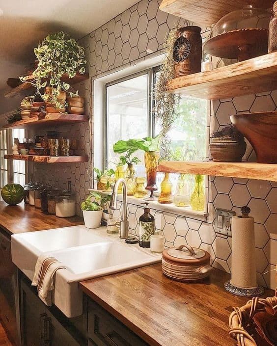 a kitchen filled with lots of wooden counter top space next to a white sink and window